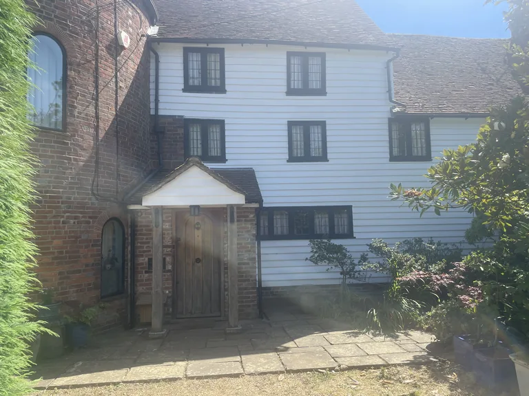 Completed weatherboard restoration and repainting to the front porch elevation of a Grade II listed oast house in Northiam, East Sussex