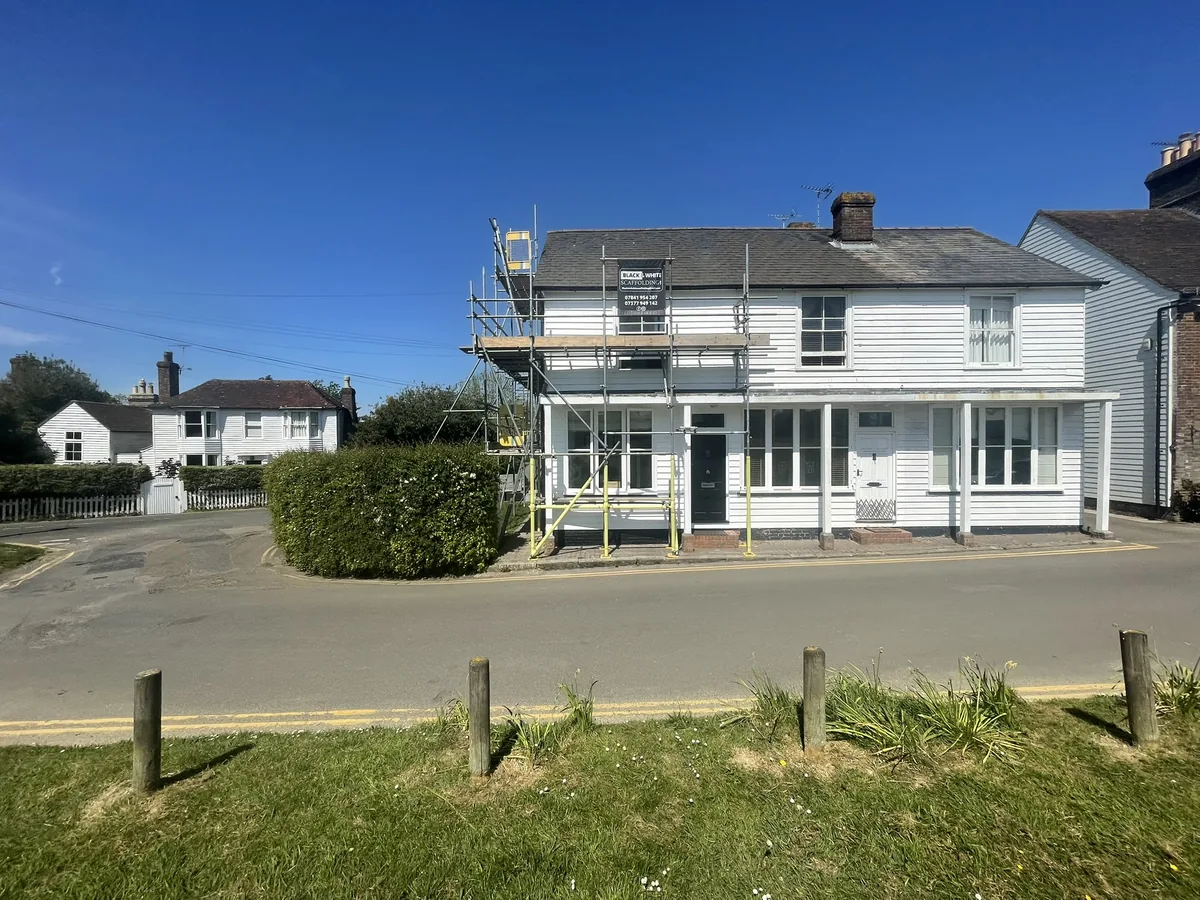 Completed opaque white weatherboard finish on a Grade II listed period property on The Moor, Hawkhurst