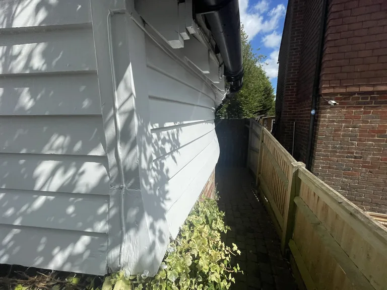Finished weatherboards to a curved section of wall after repair and repainting in Mountfield