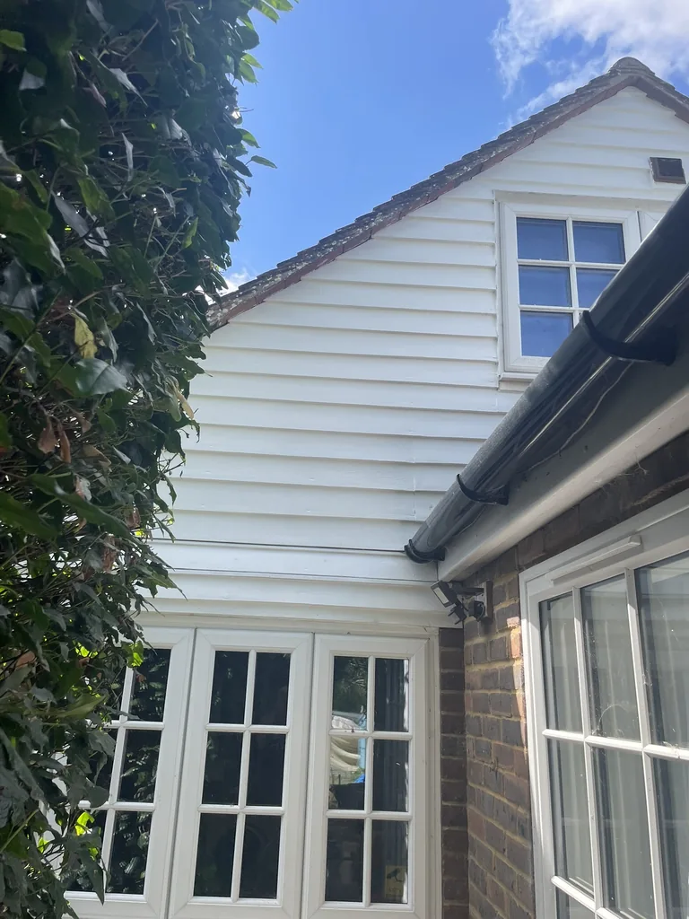 Finished rear weatherboards in satin white after repair and repainting in Mountfield