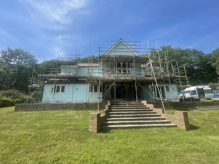 Large weatherboarded property in Biddenden during restoration with scaffolding in place