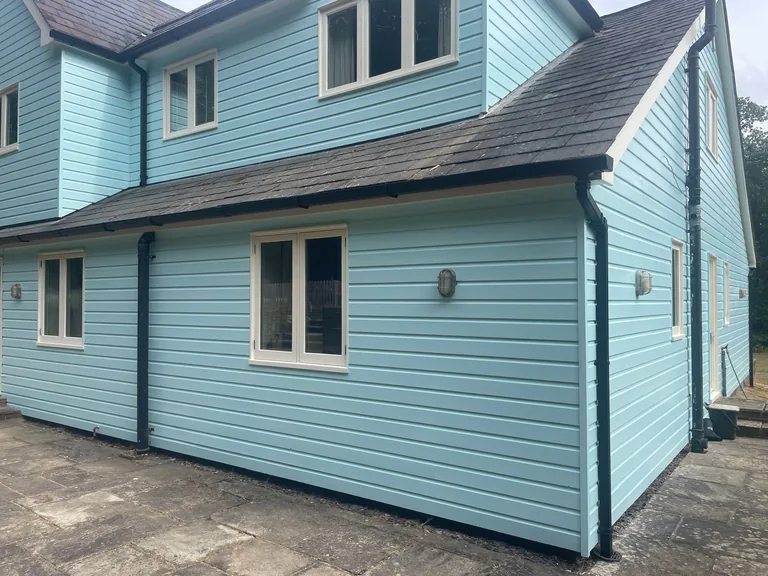 Finished weatherboarding and repaired window joinery after restoration in Biddenden
